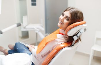 Smiling young woman in a dental chair