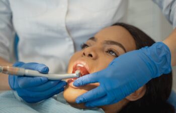 a woman gets her teeth cleaning