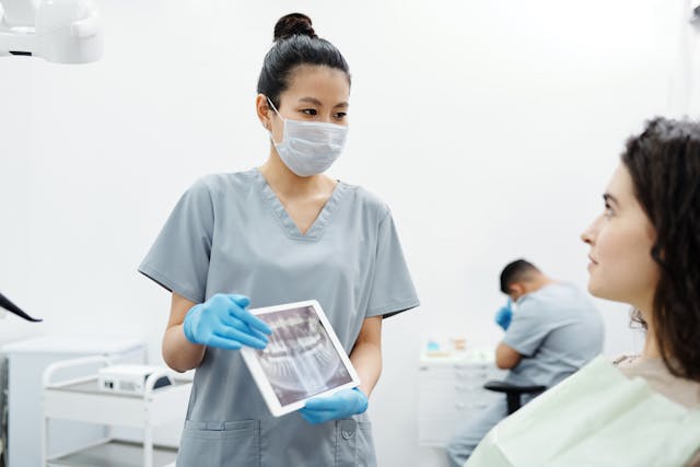 dentist shows patient an x-ray