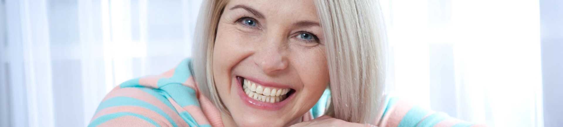 Woman smiling after dental implants in Sandy Springs
